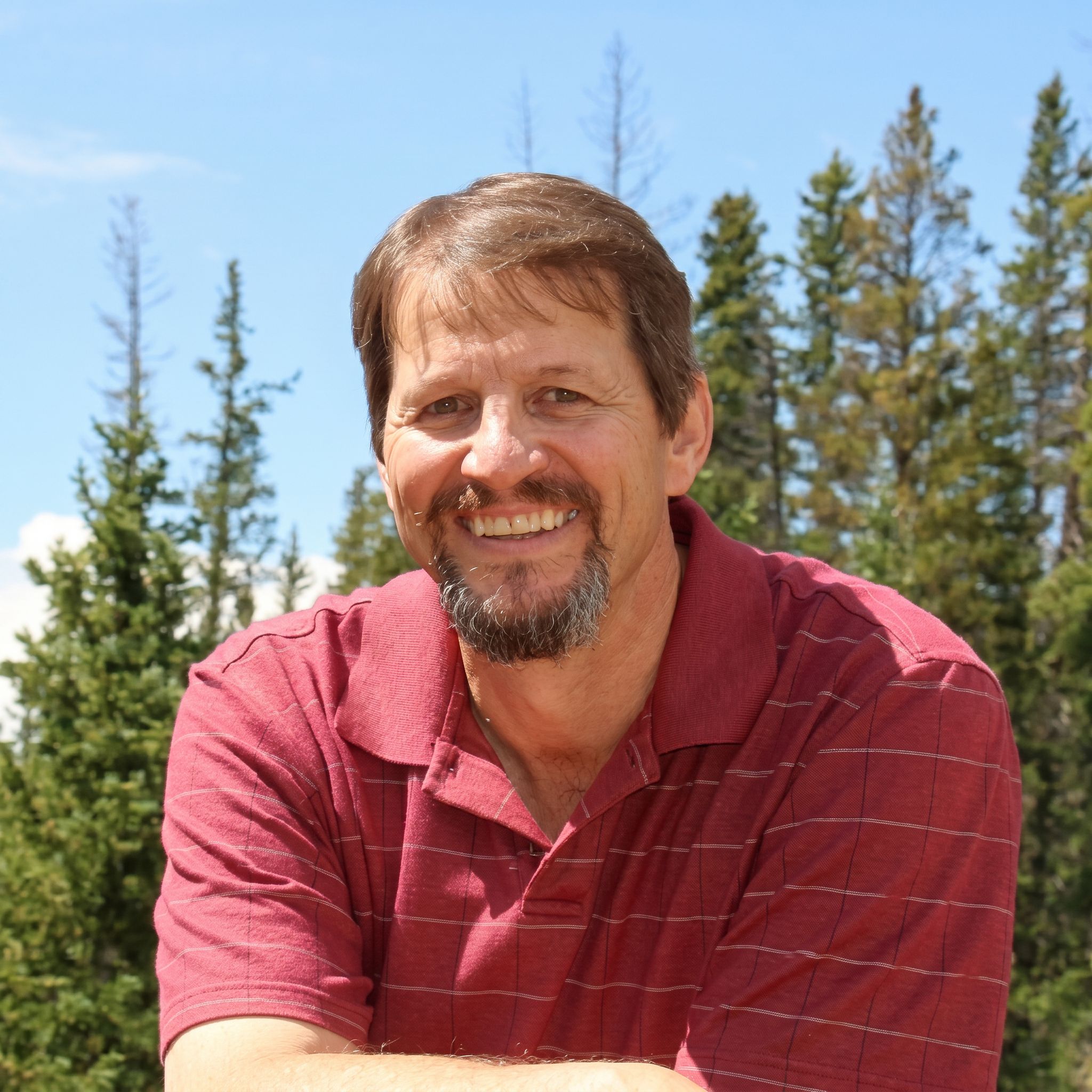 Dr. J. Dean Fitzgerald, D.C., smiling outdoors in the Uinta mountains