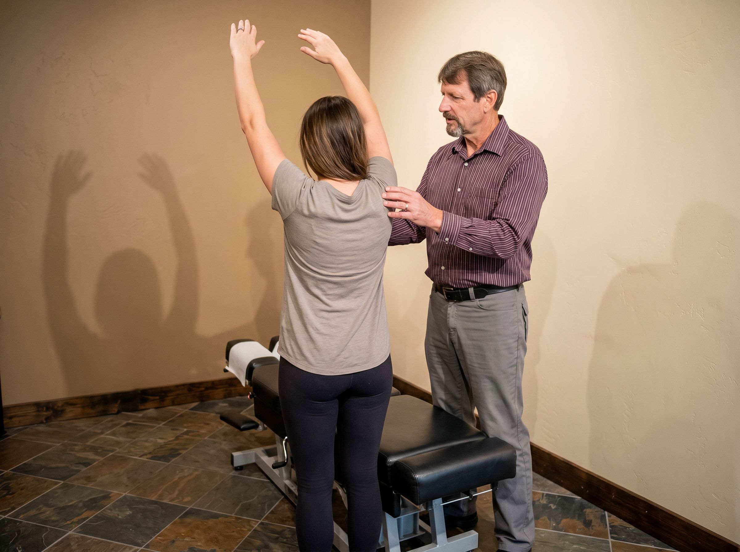 Dr. Fitzgerald guiding a patient through a supervised stretch at the Roosevelt office